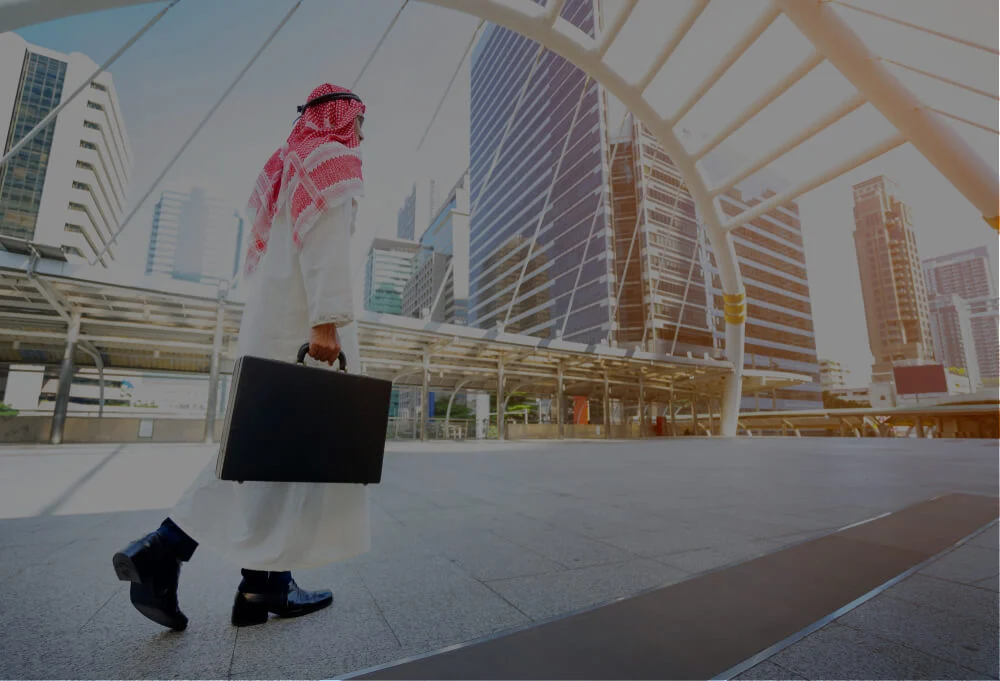 Illustrative image of a man in Gulf attire carrying a briefcase in the city