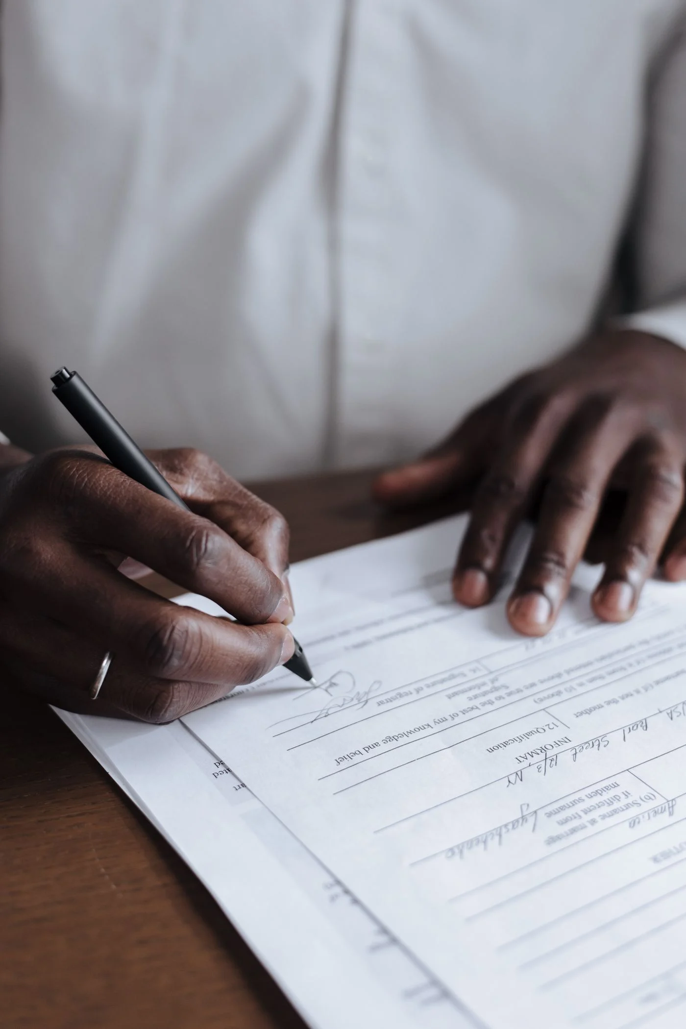 Close-up of signing a document